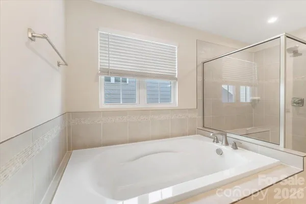 a white bath tub sitting next to a window