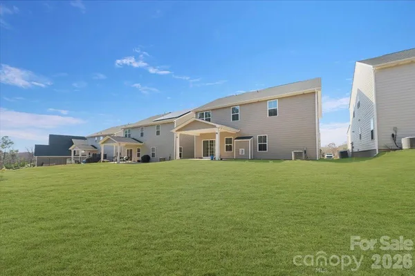 a big house with a big yard and large trees