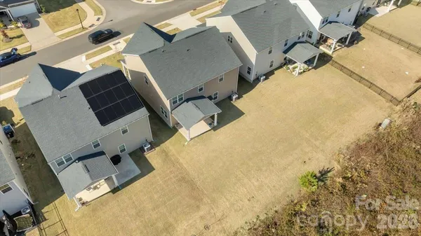 an aerial view of a large pool with lawn chairs