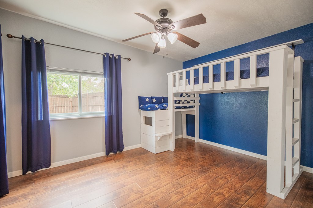 2181 Goat Creek Road Kerrville, TX 78028 - Photo 13 of 25 a view of a kitchen with a refrigerator cabinets a ceiling fan and front door
