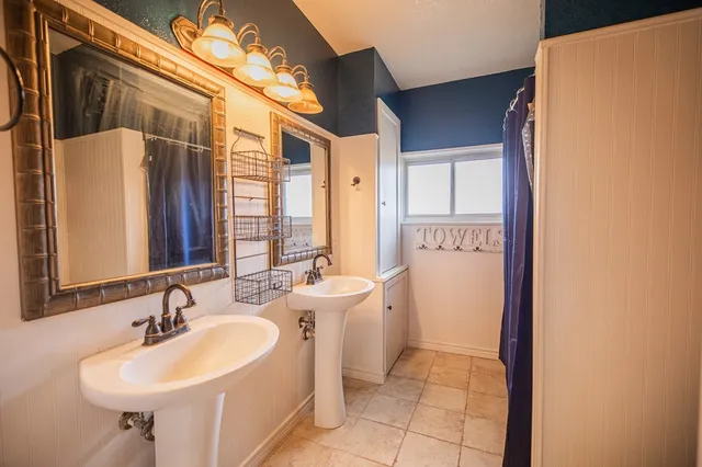 a bathroom with a sink a toilet and a mirror