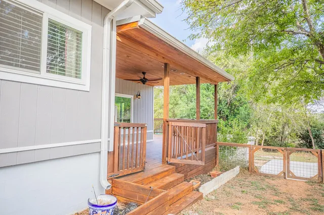 a backyard of a house with table and chairs