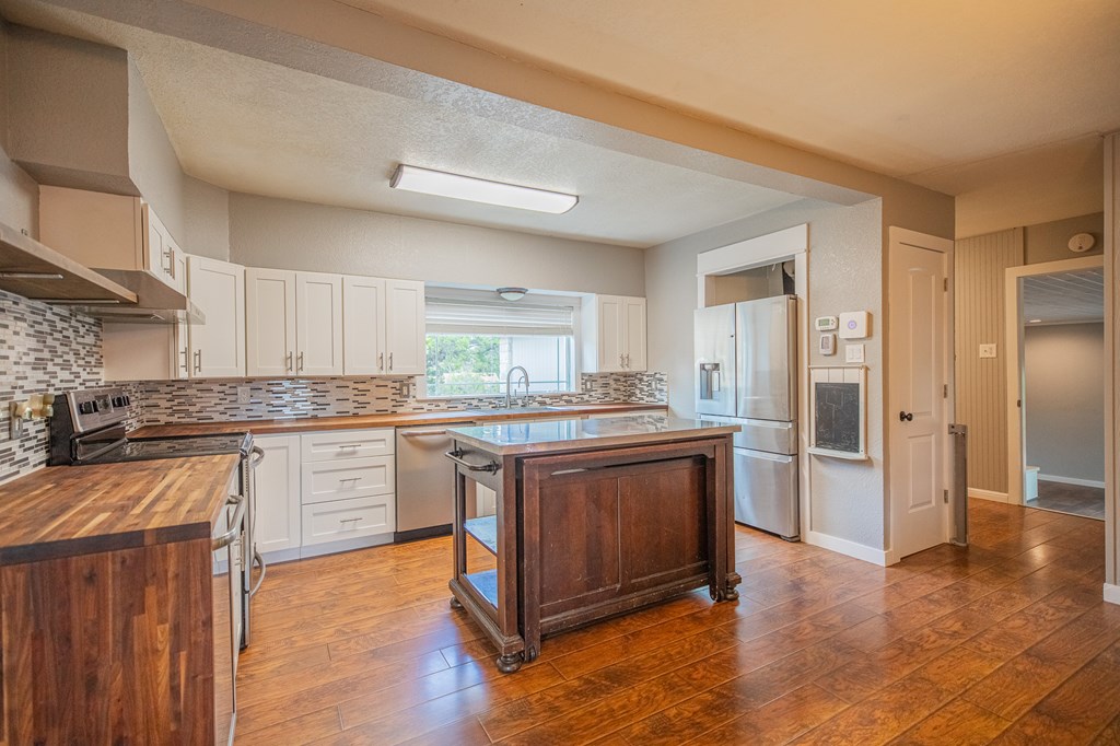 2181 Goat Creek Road Kerrville, TX 78028 - Photo 7 of 25 a kitchen with stainless steel appliances granite countertop a stove and a sink