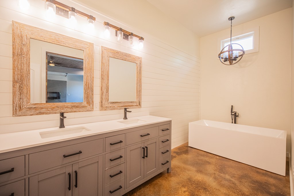 2181 Goat Creek Road Kerrville, TX 78028 - Photo 10 of 25 a bathroom with a double vanity sink mirror and bathtub