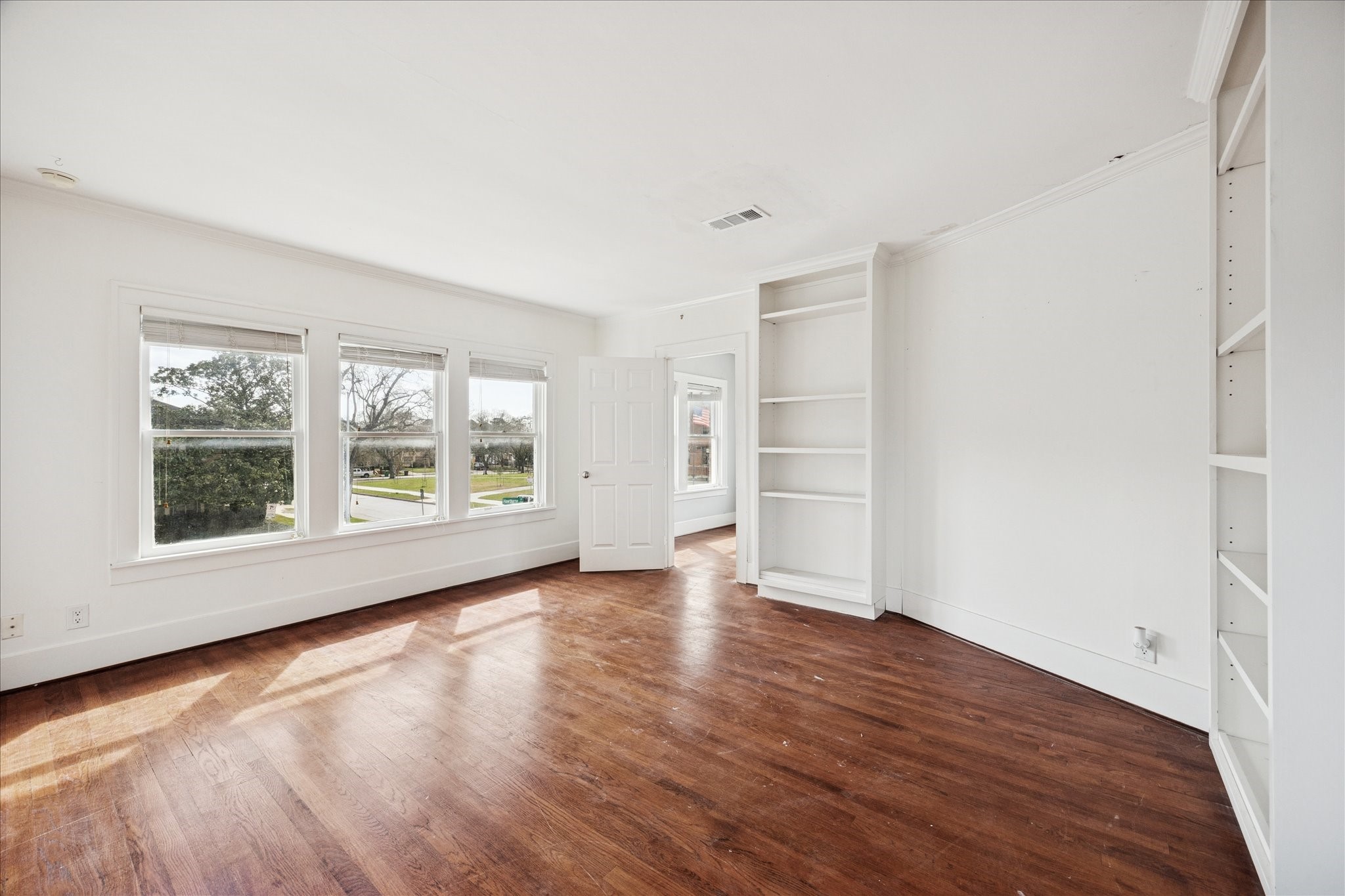 1758 Hawthorne Street Houston, TX 77098 - Photo 11 of 27 an empty room with wooden floor and windows