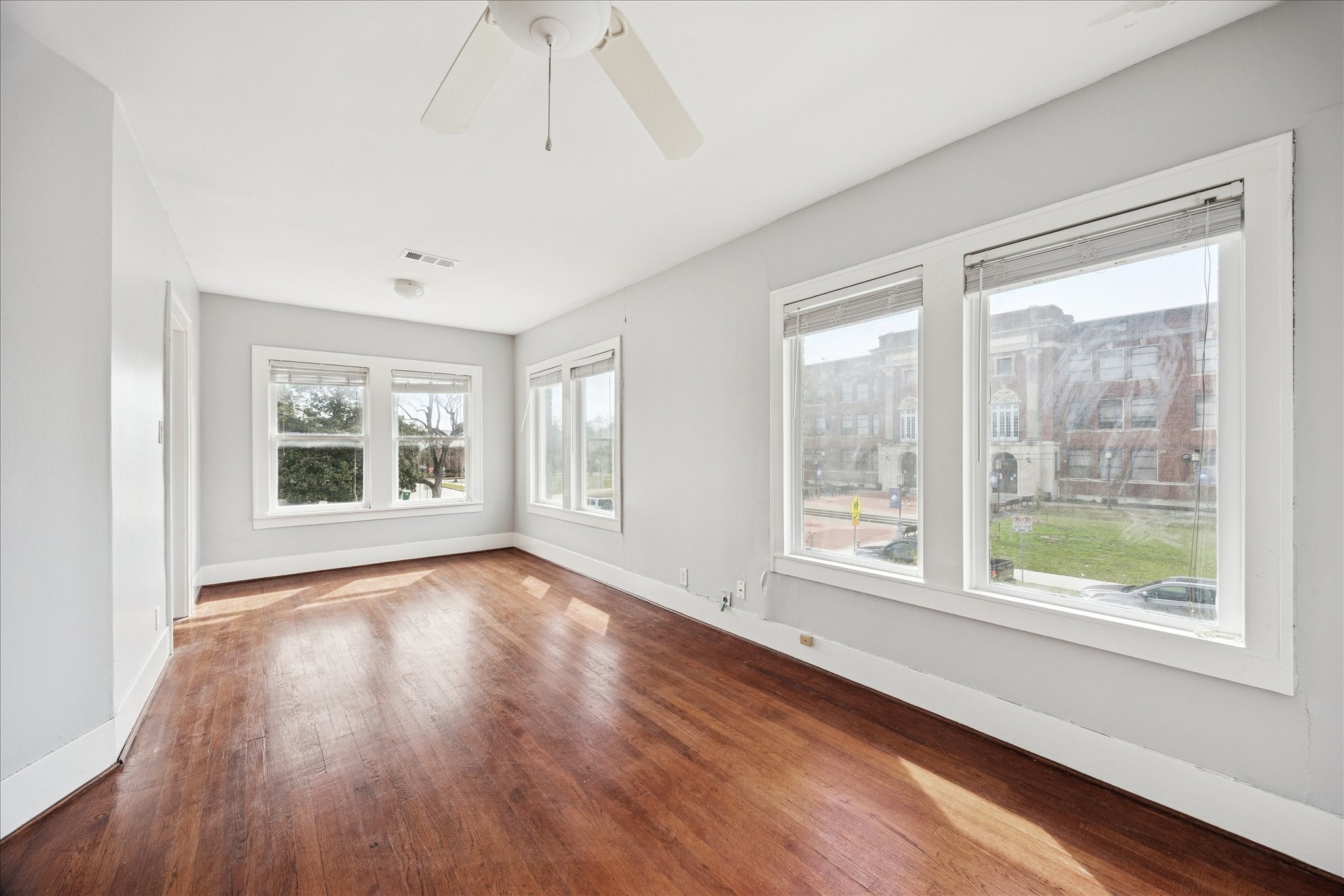 1758 Hawthorne Street Houston, TX 77098 - Photo 12 of 27 a view of an empty room with wooden floor and a window