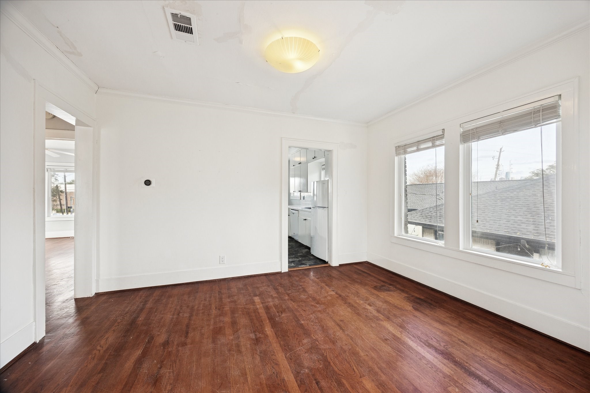 1758 Hawthorne Street Houston, TX 77098 - Photo 13 of 27 a view of an empty room with wooden floor and a window
