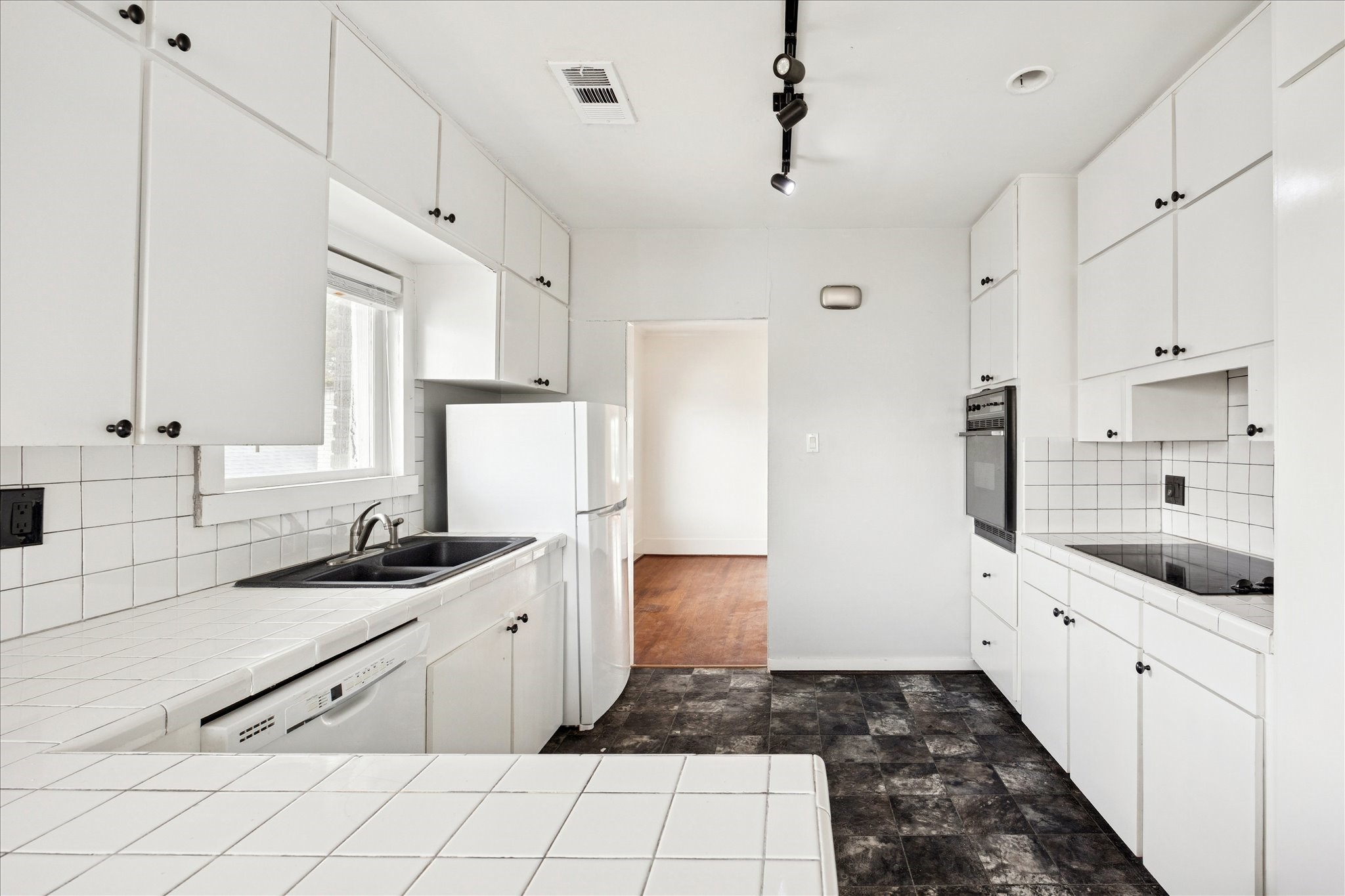1758 Hawthorne Street Houston, TX 77098 - Photo 16 of 27 a kitchen with granite countertop white cabinets and white appliances