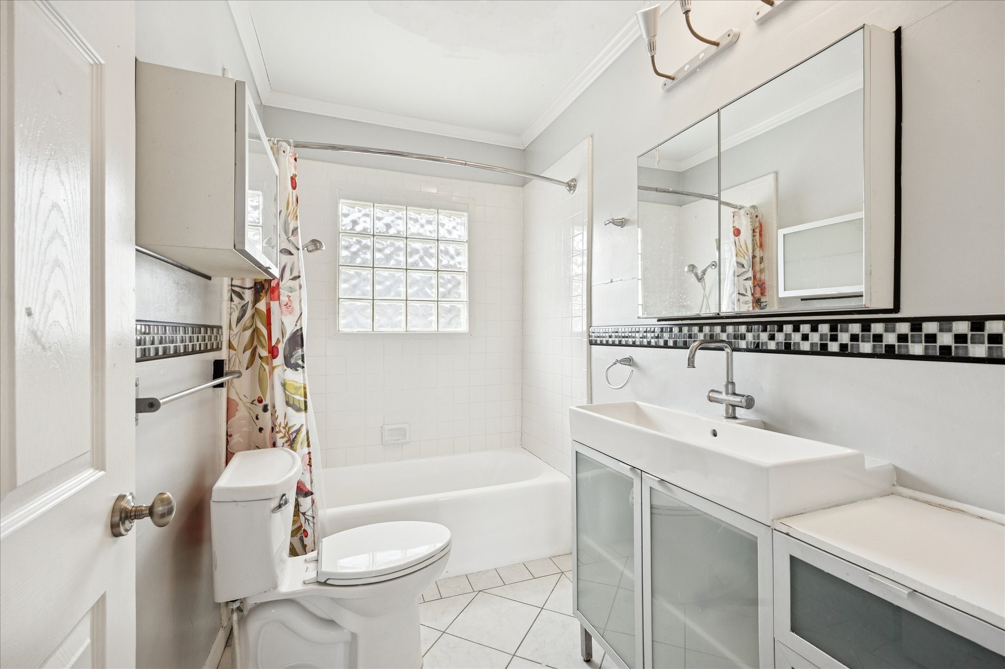 1758 Hawthorne Street Houston, TX 77098 - Photo 18 of 27 a bathroom with a sink a toilet a mirror and shower