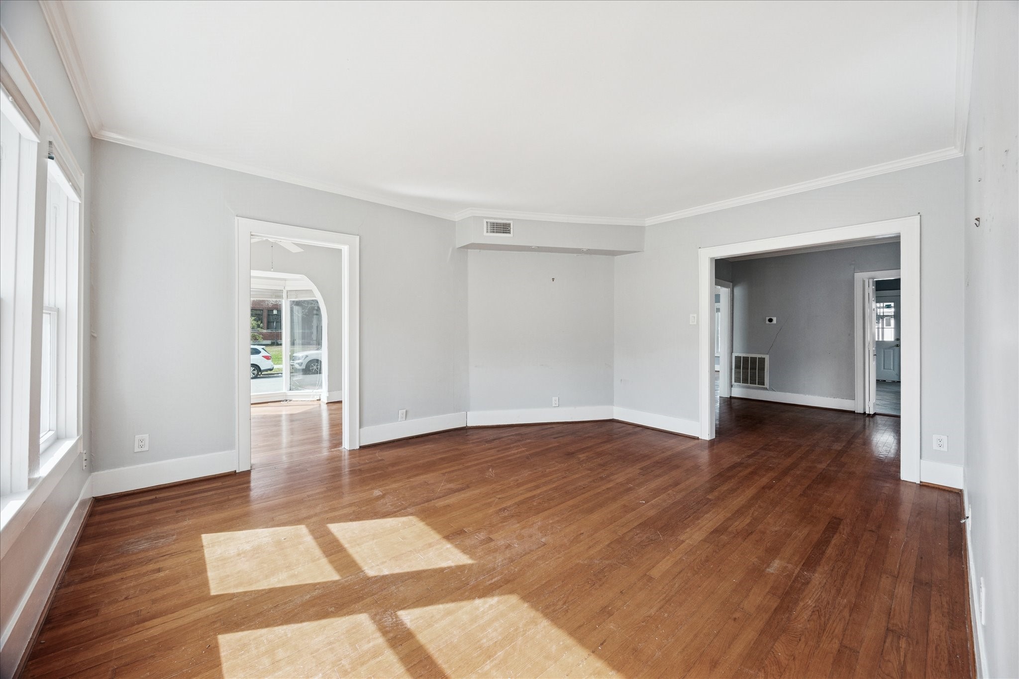 1758 Hawthorne Street Houston, TX 77098 - Photo 3 of 27 a view of an empty room with wooden floor and a window