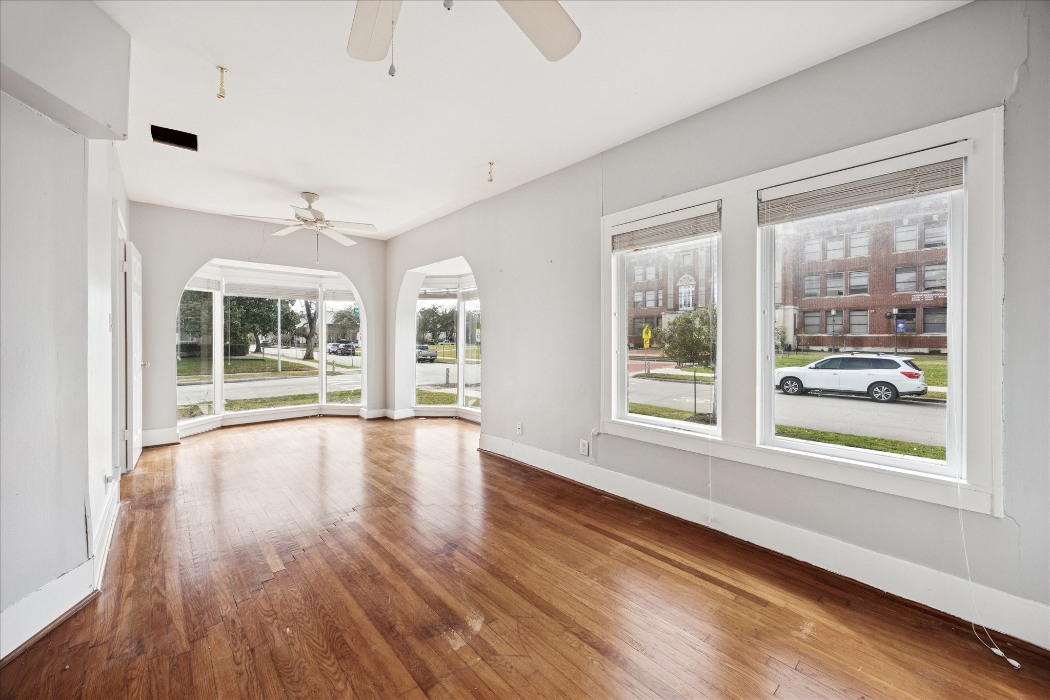1758 Hawthorne Street Houston, TX 77098 - Photo 5 of 27 a view of an empty room with a window and wooden floor