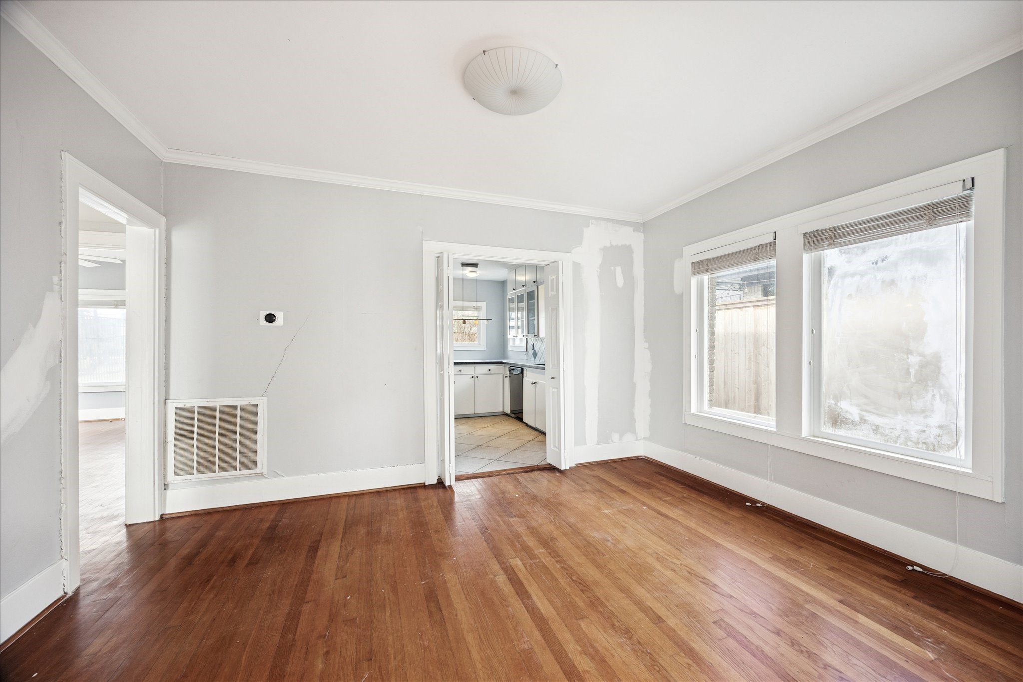 1758 Hawthorne Street Houston, TX 77098 - Photo 6 of 27 a view of an empty room with wooden floor and a window