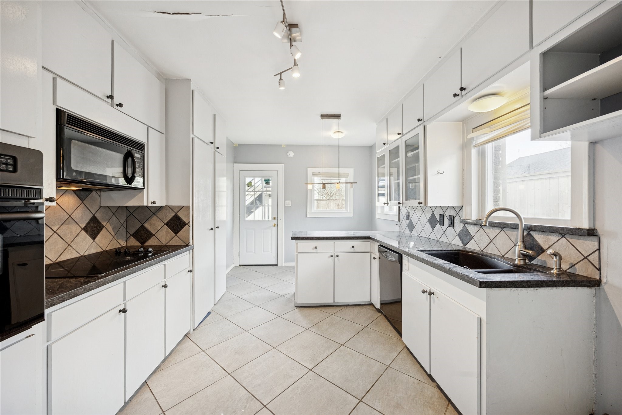 1758 Hawthorne Street Houston, TX 77098 - Photo 7 of 27 a kitchen with granite countertop a sink and cabinets