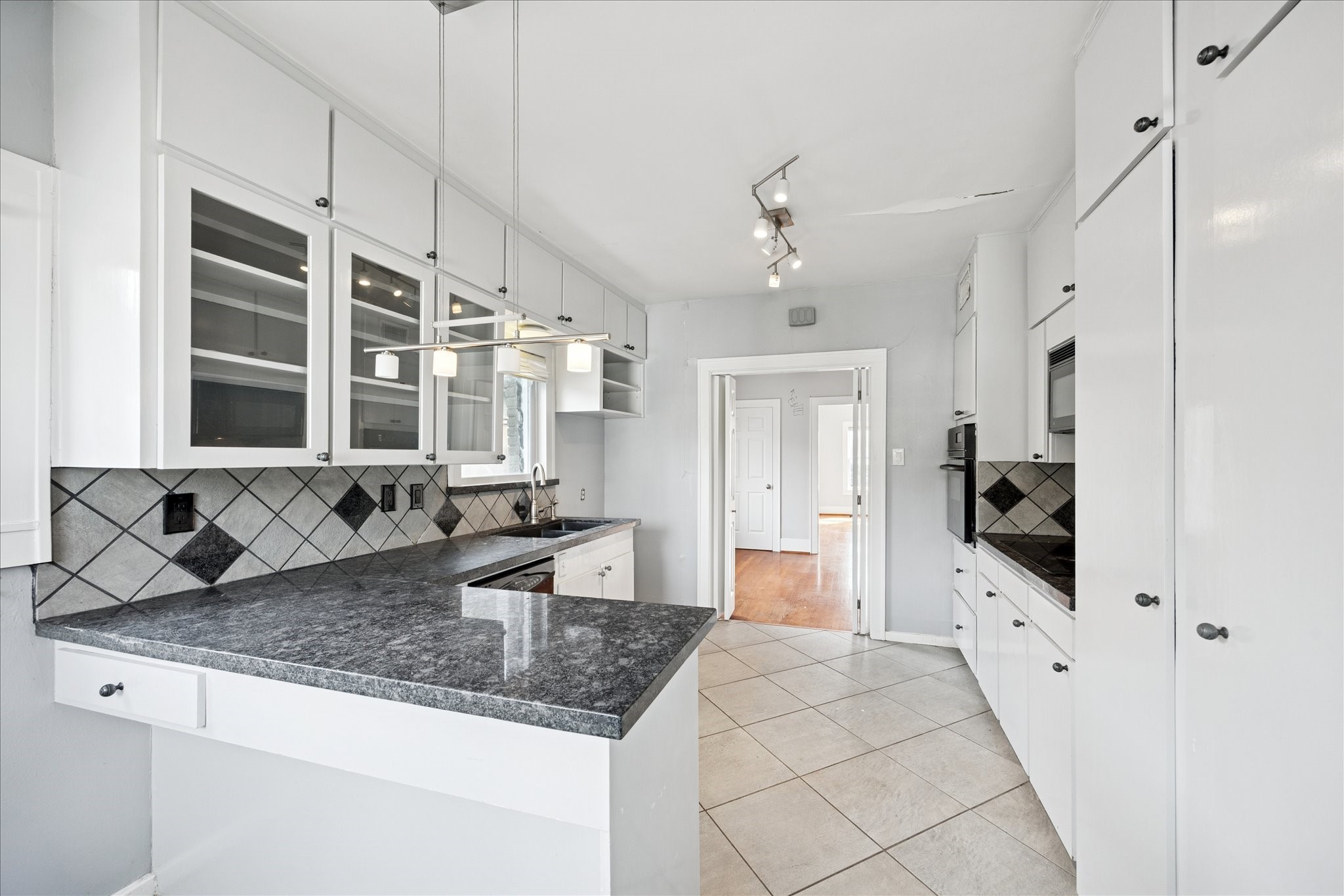1758 Hawthorne Street Houston, TX 77098 - Photo 8 of 27 a kitchen with granite countertop a sink a counter top space and stainless steel appliances