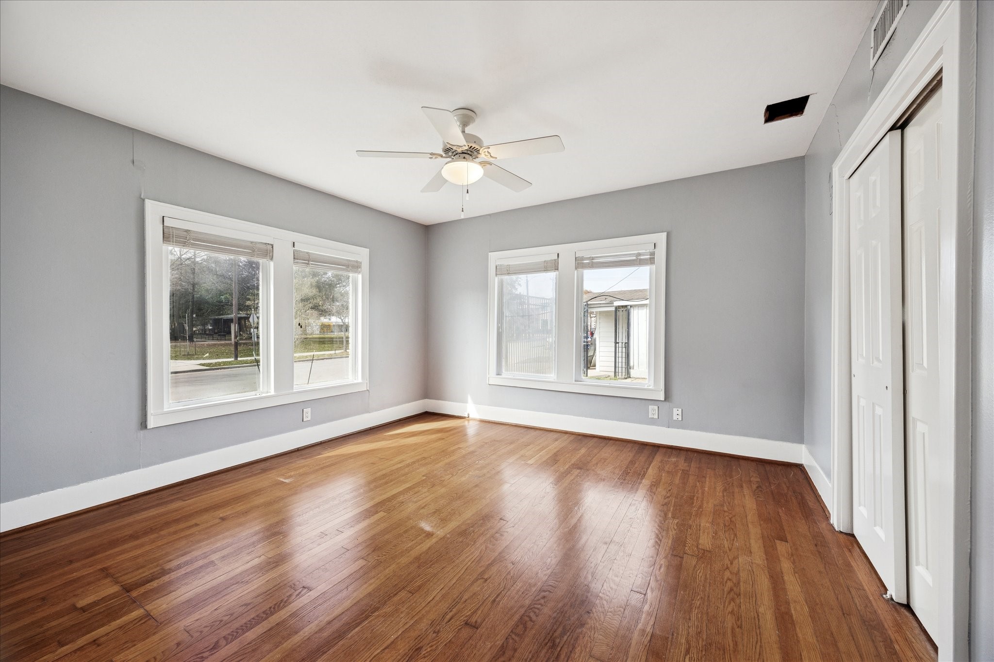 1758 Hawthorne Street Houston, TX 77098 - Photo 9 of 27 a view of an empty room with wooden floor and a window
