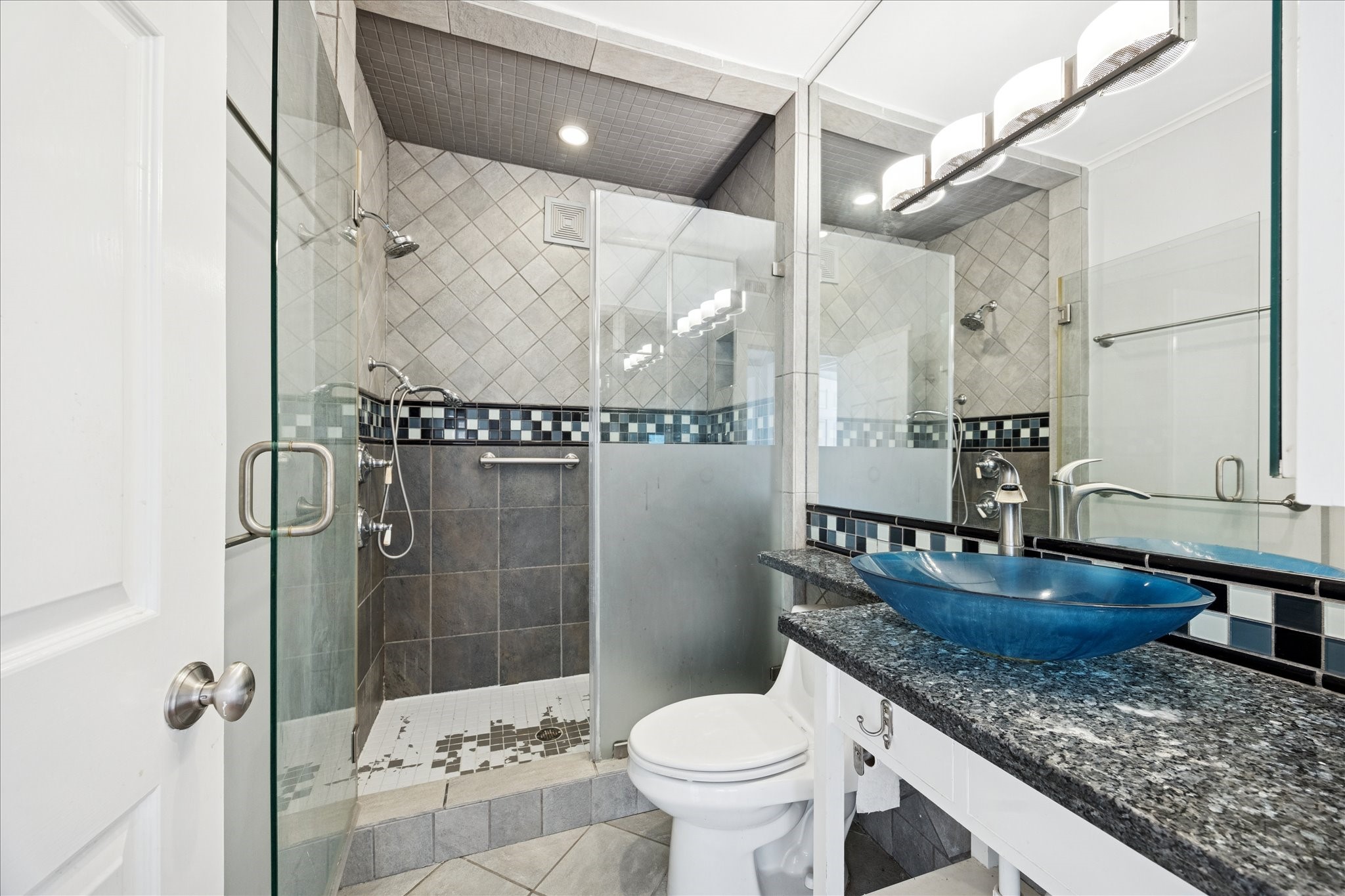 1758 Hawthorne Street Houston, TX 77098 - Photo 10 of 27 a bathroom with a granite countertop sink a toilet and shower