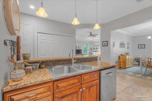 a kitchen with stainless steel appliances granite countertop a sink a counter space and cabinets