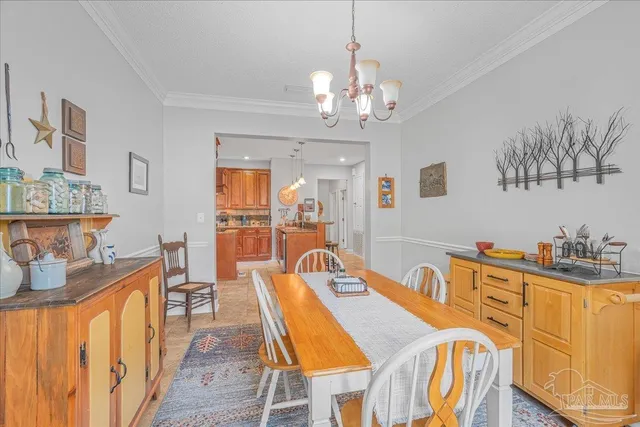 a dining room with wooden floor a chandelier a wooden table and chairs