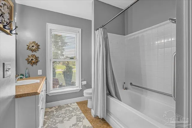 a bathroom with a tub sink and window