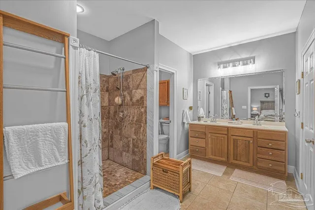 a bathroom with a granite countertop sink a mirror a bathtub and shower