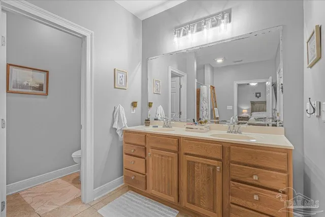 a bathroom with a double vanity sink and a mirror