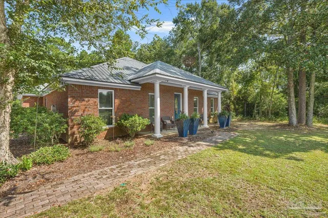 a front view of a house with a garden