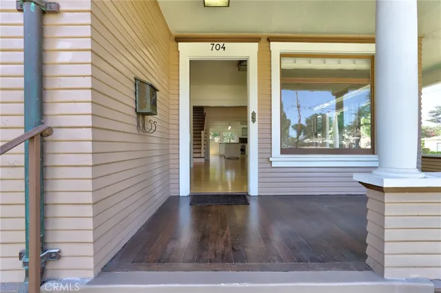 a view of a hallway with wooden floor and a fireplace