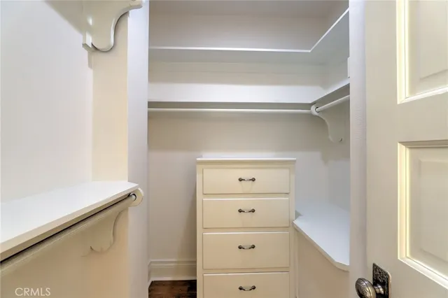a view of a house with brick walls and a yard with plants