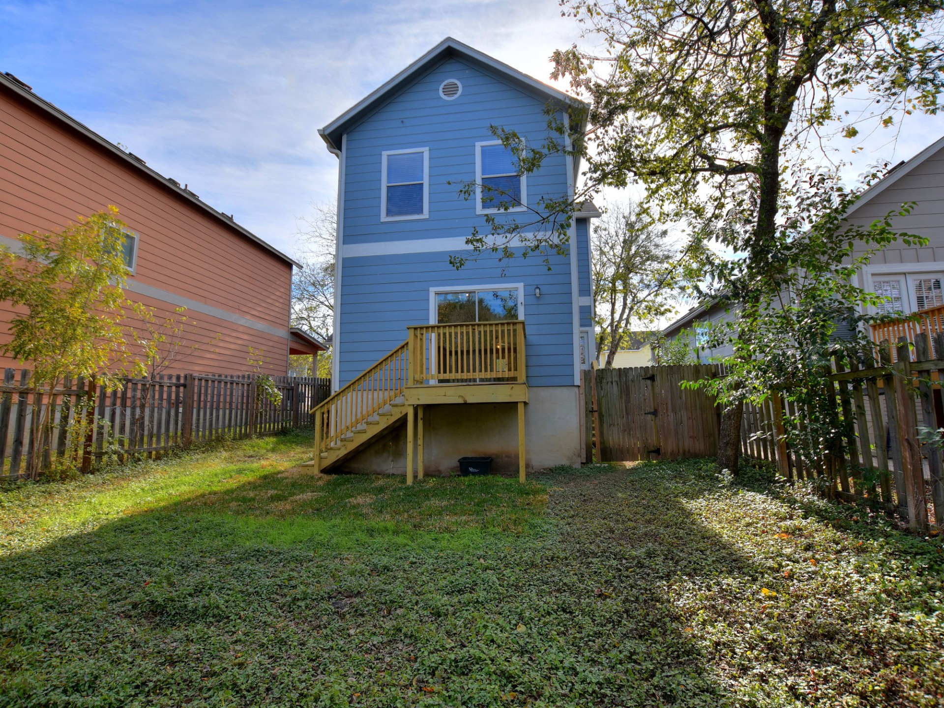 917 East 3rd Street Georgetown, TX 78626 - Photo 19 of 23 A quaint backyard with a raised wooden deck, perfect for outdoor enjoyment.