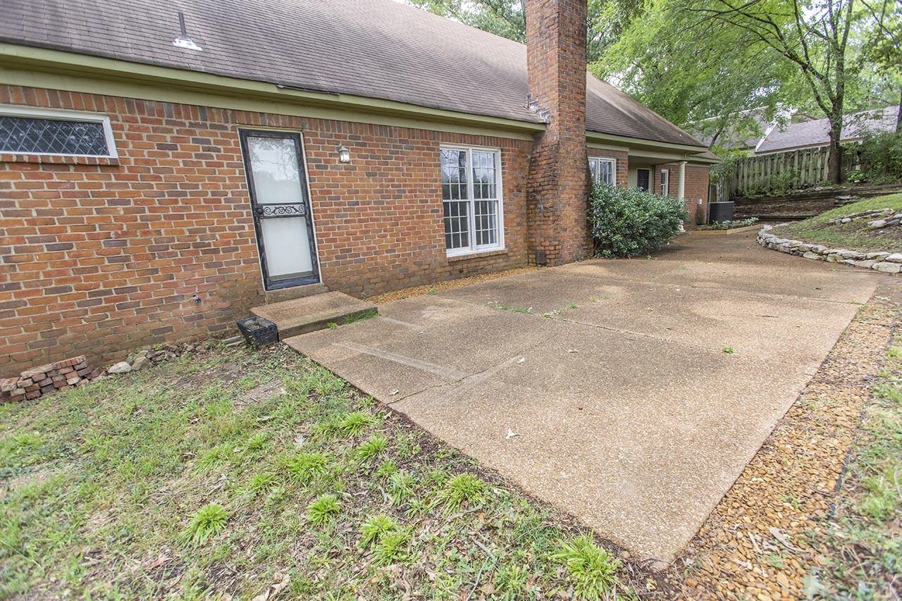 124 South Walnut Bend Road Memphis, TN 38018 - Photo 17 of 22 a front view of a house with a garden