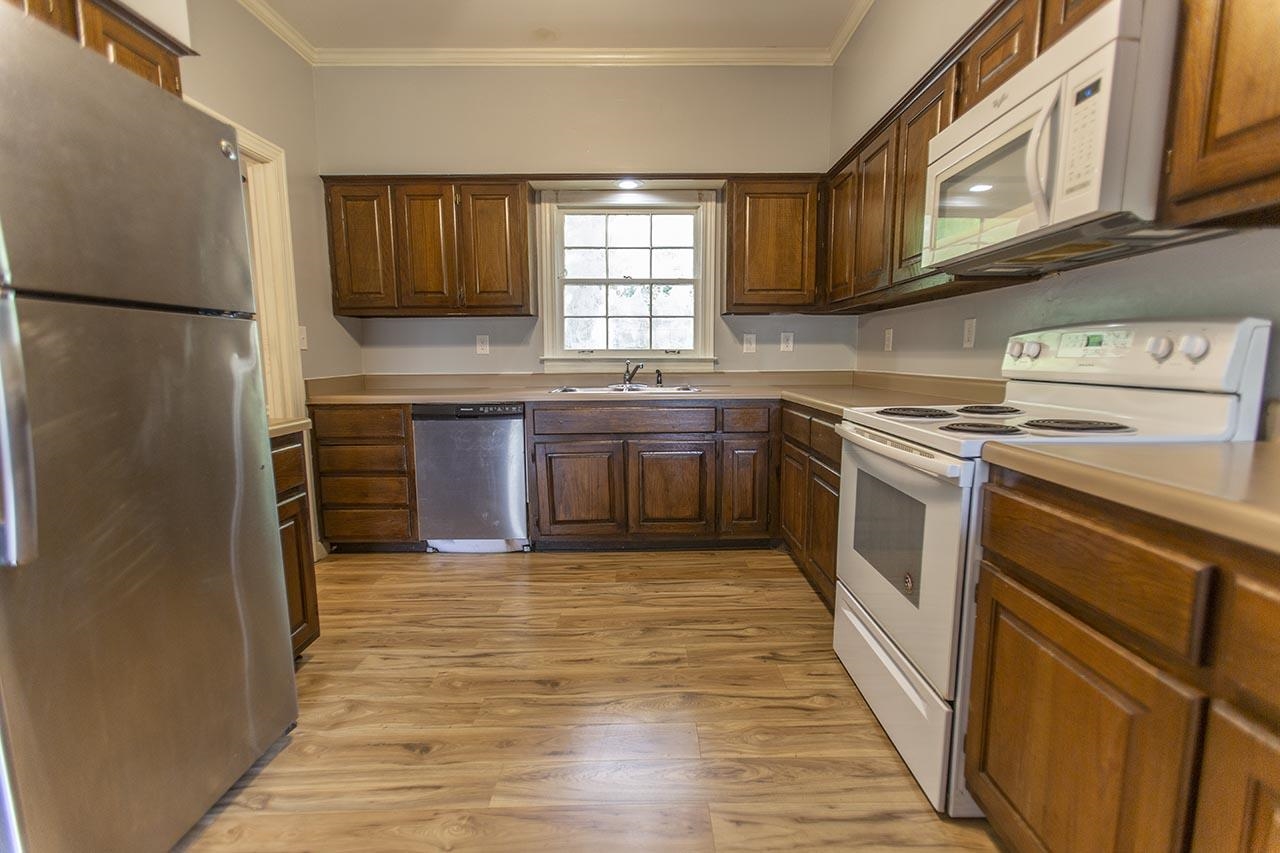 124 South Walnut Bend Road Memphis, TN 38018 - Photo 4 of 22 a kitchen with stainless steel appliances granite countertop a stove a sink dishwasher and a refrigerator