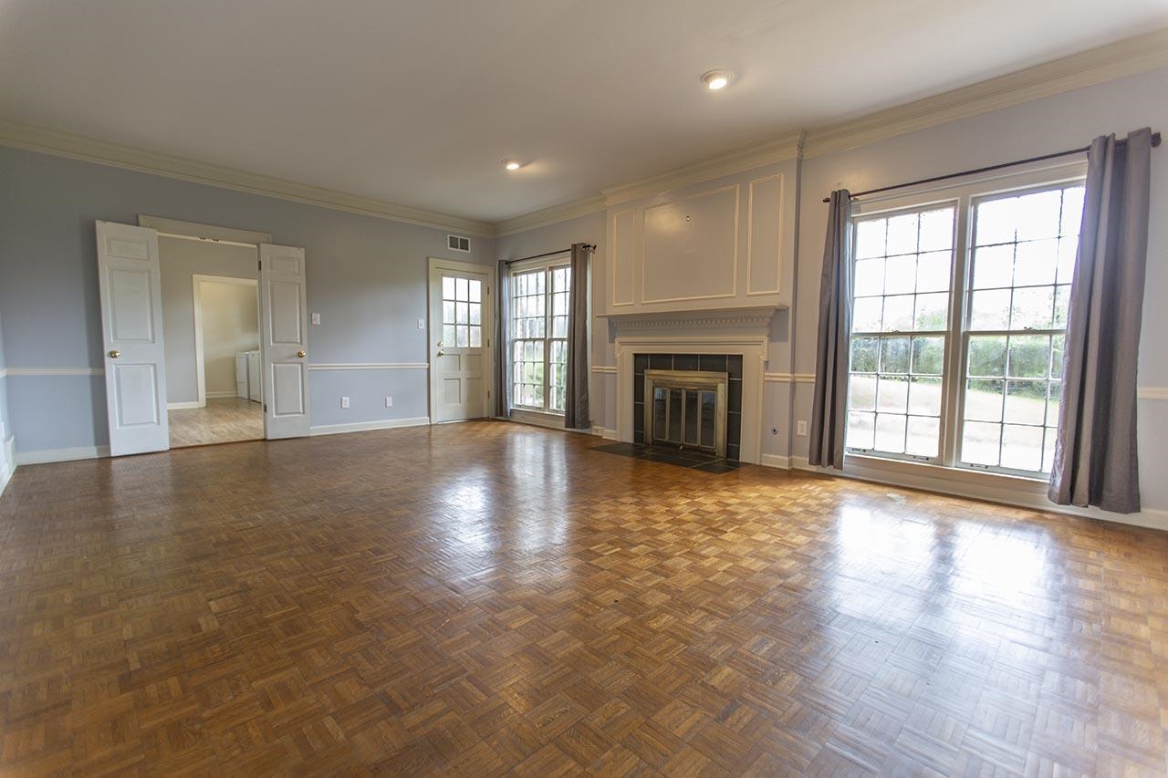 124 South Walnut Bend Road Memphis, TN 38018 - Photo 6 of 22 wooden floor fireplace and windows in an empty room