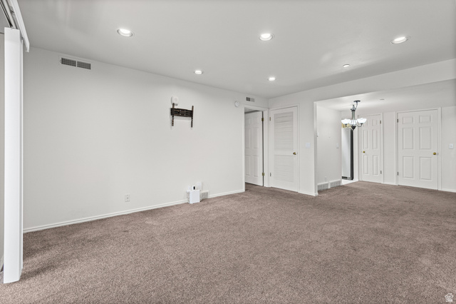 2244 North Canyon Road, Unit 212 Provo, UT 84604 - Photo 12 of 31 Recessed lighting, neutral-toned carpeting, white interior doors, and a chandelier with glass shades
