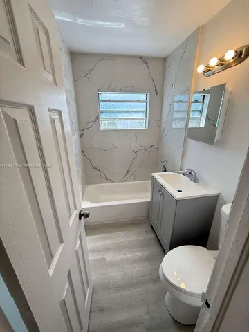 a bathroom with a toilet sink and a bathtub
