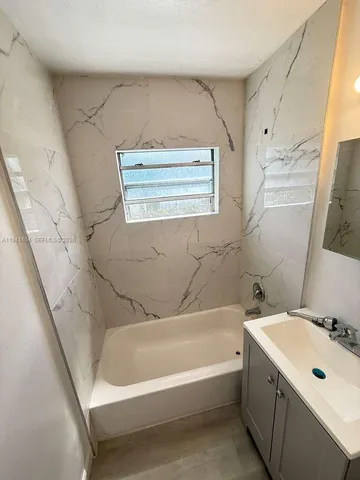 a bathroom with a bathtub and a sink