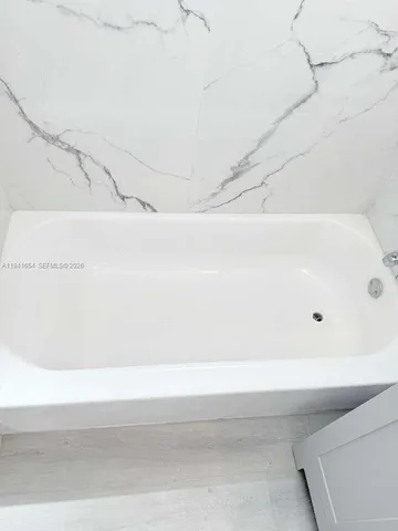 a bathroom with a bathtub and shower