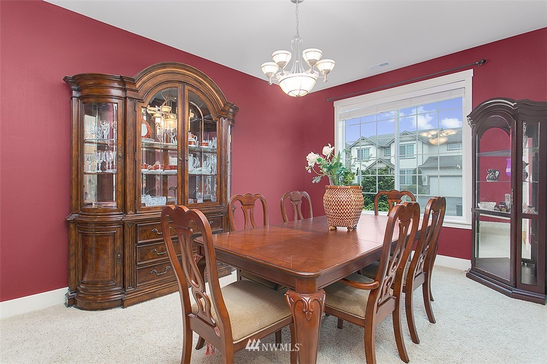21913 42 Avenue Southeast Bothell, WA 98021 - Photo 11 of 24 a view of a dining room with furniture and chandelier