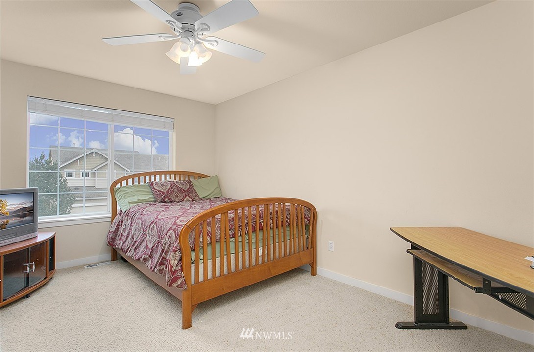 21913 42 Avenue Southeast Bothell, WA 98021 - Photo 16 of 24 a bedroom with a bed and a chandelier