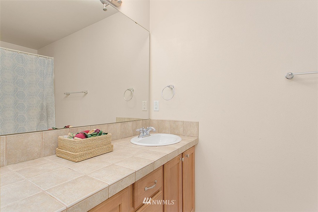 21913 42 Avenue Southeast Bothell, WA 98021 - Photo 17 of 24 a bathroom with a sink and a mirror