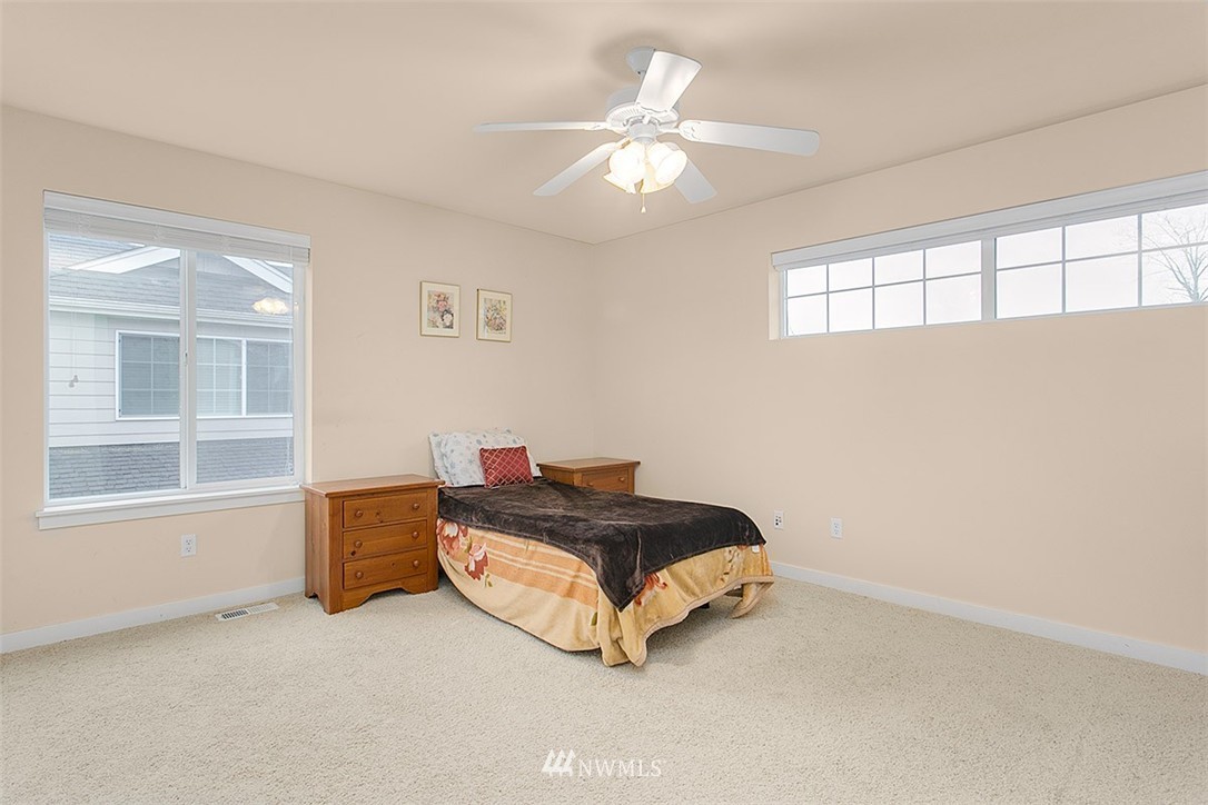 21913 42 Avenue Southeast Bothell, WA 98021 - Photo 18 of 24 a spacious bedroom with a bed and window