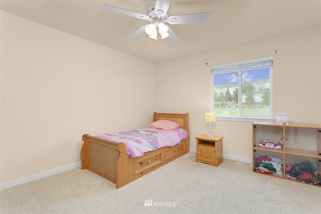 21913 42 Avenue Southeast Bothell, WA 98021 - Photo 19 of 24 a living room with a bed furniture and a window