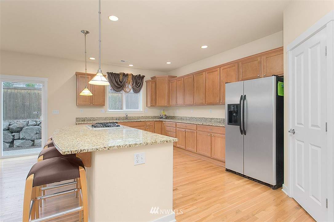 21913 42 Avenue Southeast Bothell, WA 98021 - Photo 4 of 24 a kitchen with stainless steel appliances granite countertop a refrigerator and a sink