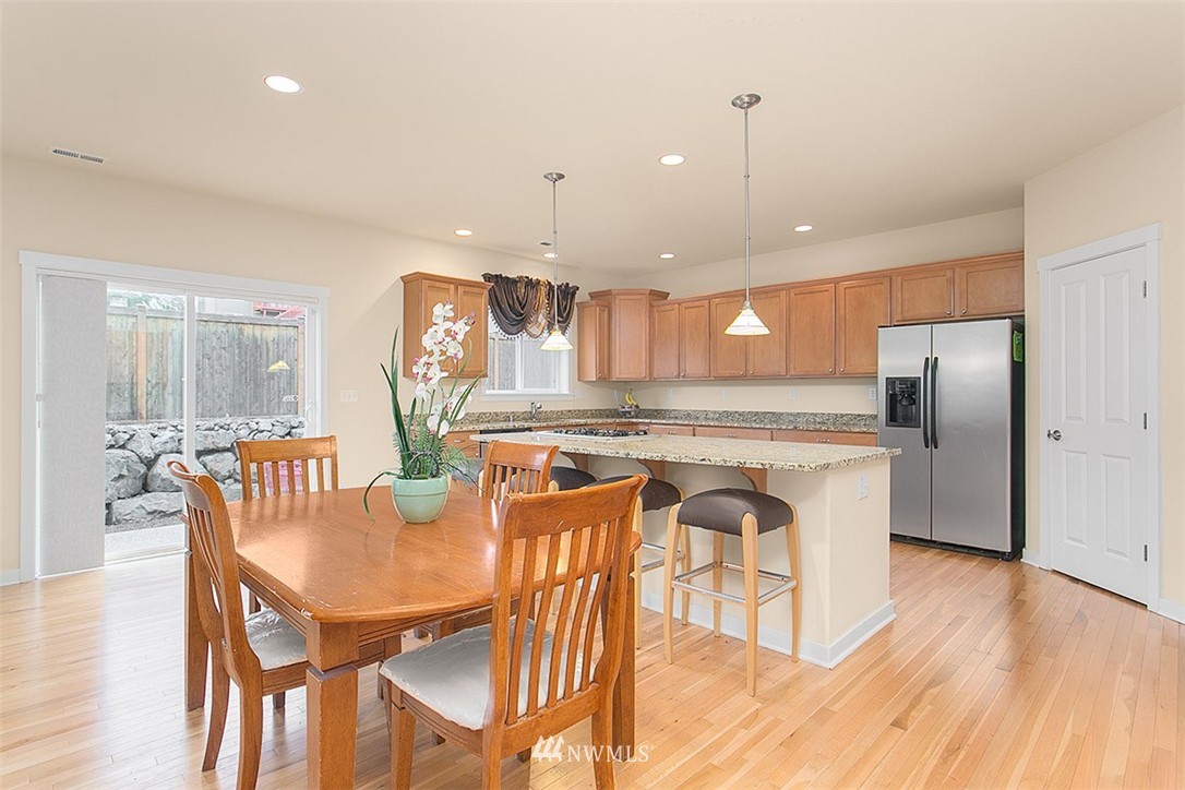 21913 42 Avenue Southeast Bothell, WA 98021 - Photo 6 of 24 a view of a dining room with furniture a kitchen and chandelier