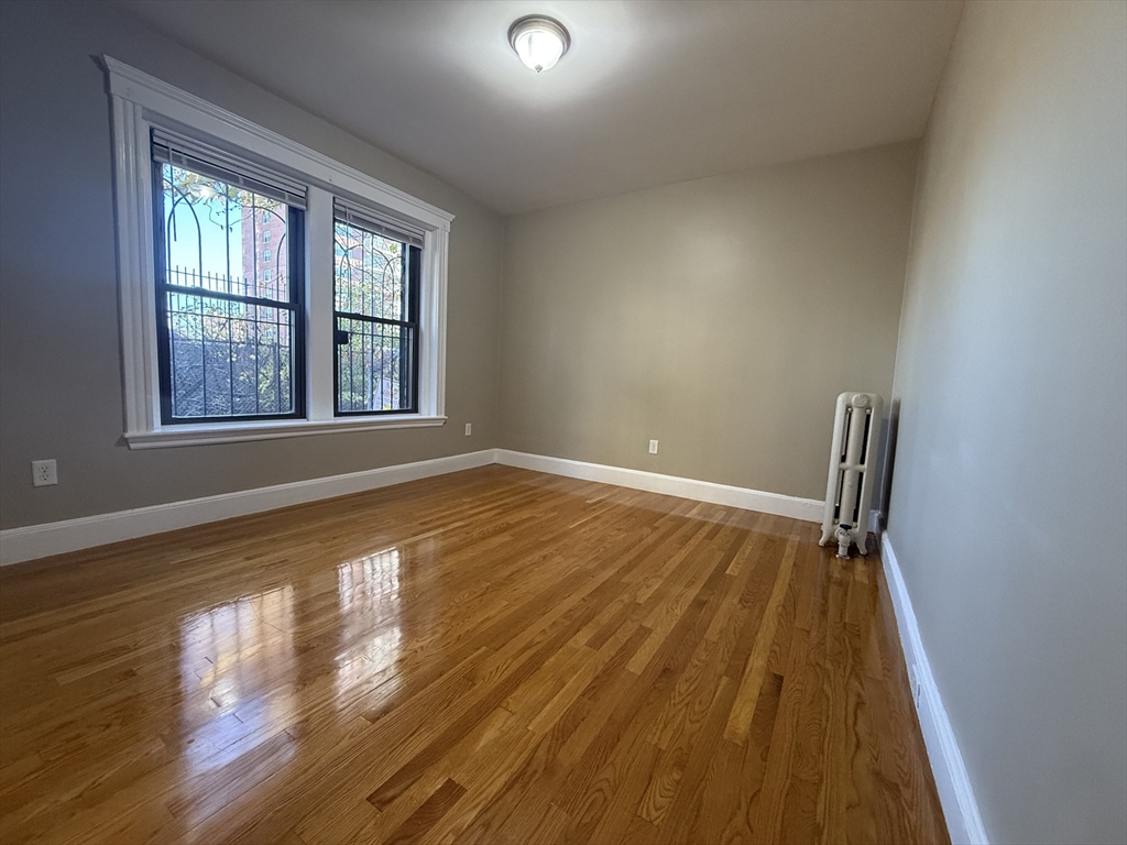 660 Huntington Avenue, Unit 18 Boston, MA 02115 - Photo 2 of 23 a view of an empty room with wooden floor and a window
