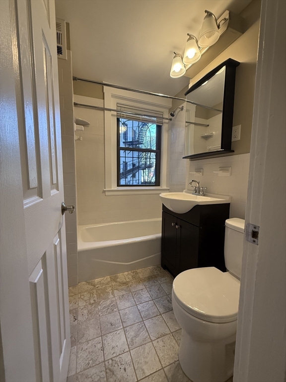 660 Huntington Avenue, Unit 18 Boston, MA 02115 - Photo 7 of 23 a bathroom with a sink a toilet a mirror and bathtub