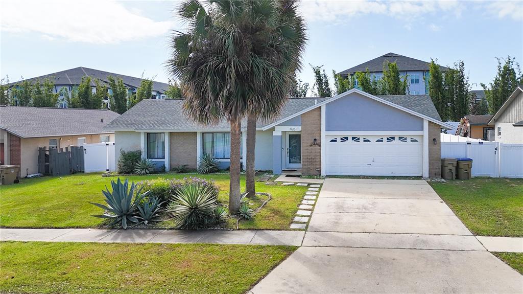 a front view of a house with a yard table and chairs