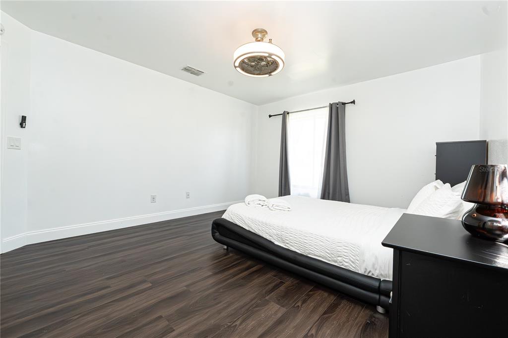 7720 Indian Ridge Trail South Kissimmee, FL 34747 - Photo 13 of 35 a bedroom with a bed and a window