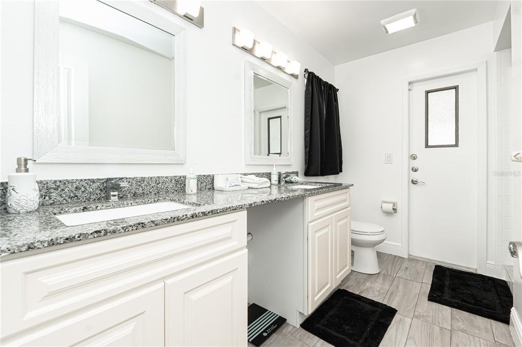 7720 Indian Ridge Trail South Kissimmee, FL 34747 - Photo 14 of 35 a bathroom with a sink and a mirror