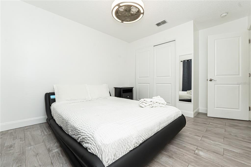 7720 Indian Ridge Trail South Kissimmee, FL 34747 - Photo 16 of 35 a bedroom with a bed and painting on the wall