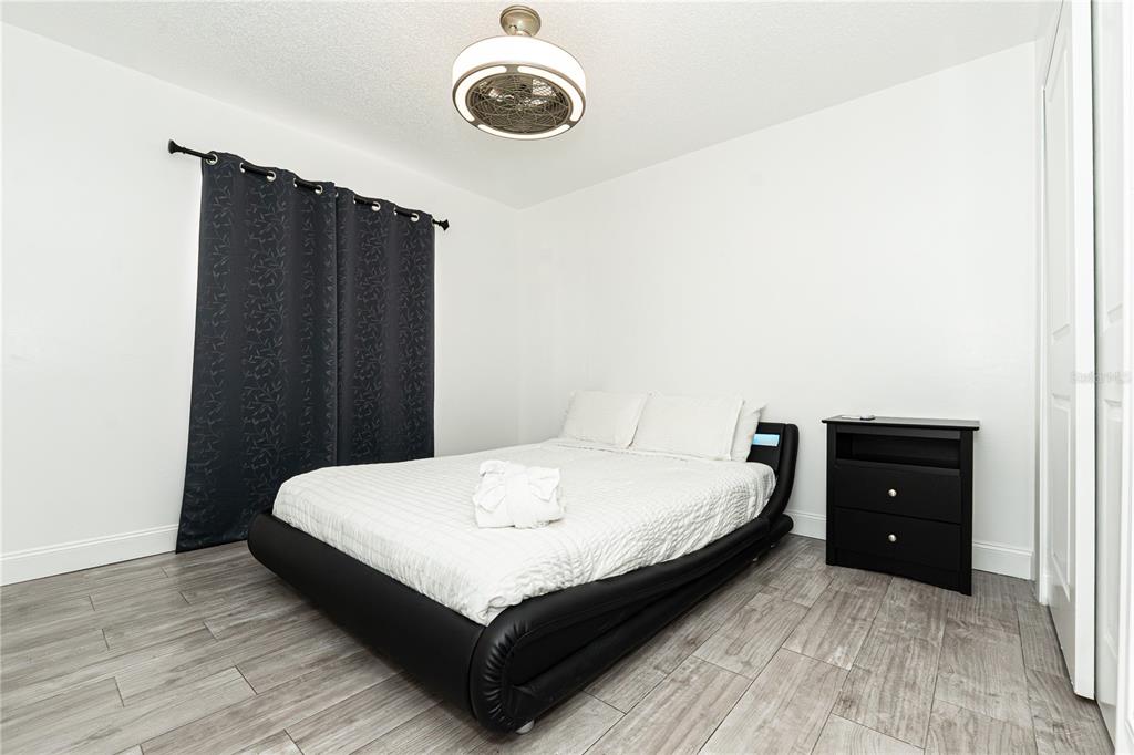 7720 Indian Ridge Trail South Kissimmee, FL 34747 - Photo 17 of 35 a bedroom with a bed and a dresser